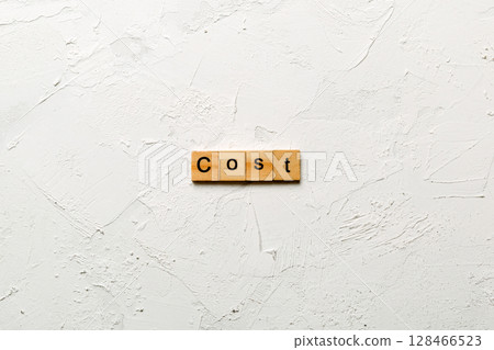 COST word written on wood block. COST text on table, concept 128466523