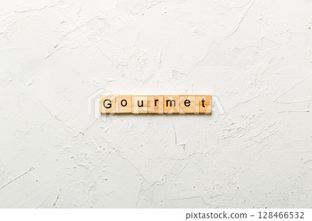 gourmet word written on wood block. gourmet text on cement table for your desing, concept 128466532