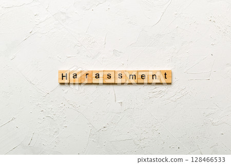harassment word written on wood block. harassment text on cement table for your desing, concept 128466533