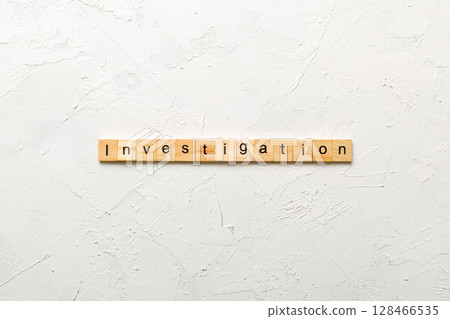 investigation word written on wood block. investigation text on table, concept 128466535
