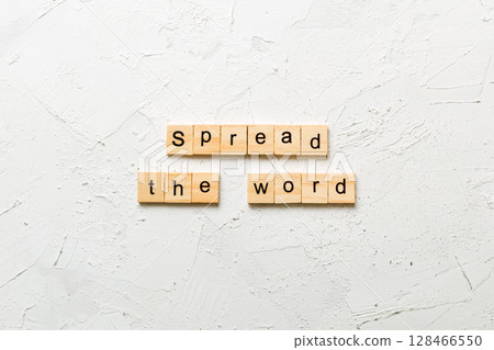 Spread the word word written on wood block. Spread the word text on table, concept 128466550