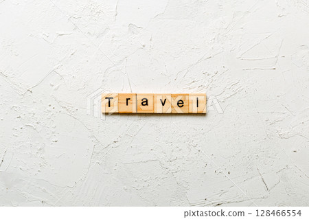 Travel word written on wood block. Travel text on cement table for your desing, concept Travel word written on wood block. Travel text on cement table for your desing, concept 128466554
