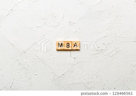 MBA word written on wood block. Master of Business Administration text on table, concept 128466561