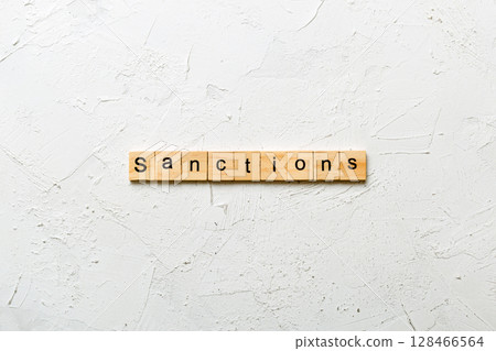sanction word written on wood block. sanction text on table, concept 128466564