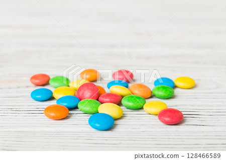 Pile of delicious colorful sweet candies on colored background top view. Confectionery decor 128466589