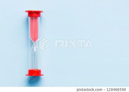 hourglass on the table, sand clock as time passing concept for business deadline, copy space 128466590