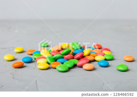 Pile of delicious colorful sweet candies on colored background top view. Confectionery decor Pile of delicious colorful sweet candies on colored background top view. Confectionery decor 128466592