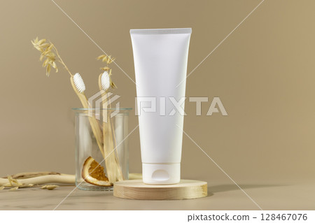 Organic oral care products set. Eco friendly still life with bio toothpaste, toothbrushes in glass jar on wooden podium with copy space. Natural teeth hygiene concept. Mockup of tube with toothpaste Organic oral care products set. Eco friendly still life with bio toothpaste, toothbrushes in glass jar on wooden podium with copy space. Natural teeth hygiene concept. Mockup of tube with toothpaste 128467076