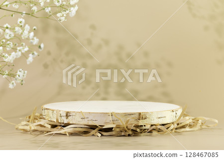 Wooden empty podium on natural beige background with white flowers and shadows. Round show case for natural cosmetic products. Concept scene stage for new product, promotion sale and presentation Wooden empty podium on natural beige background with white flowers and shadows. Round show case for natural cosmetic products. Concept scene stage for new product, promotion sale and presentation 128467085