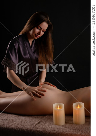 Relaxing massage session in a serene beauty studio with calming ambiance 128467205