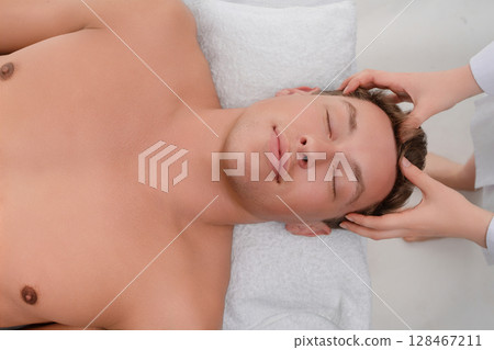 Relaxing massage session in a serene beauty studio setting 128467211