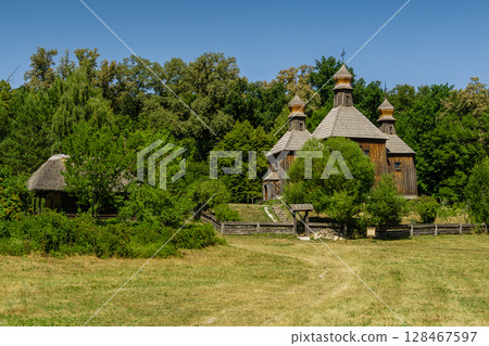 Old wooden church on a background of blue sky Old wooden church on a background of blue sky 128467597
