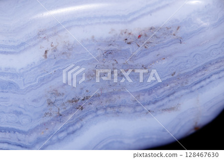 Macro mineral blue agate sapphirin in the rock on black background Macro mineral blue agate sapphirin in the rock on black background 128467630