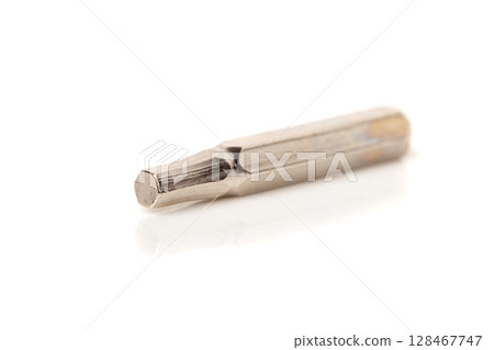 A set of different attachments for a head screwdriver with a screwdriver on a white background A set of different attachments for a head screwdriver with a screwdriver on a white background 128467747