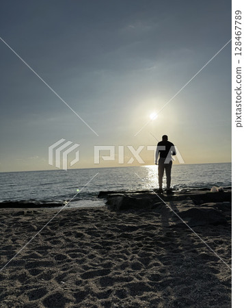 silhouette of a fisherman at sea sunset calm. High quality photo silhouette of a fisherman at sea sunset calm. High quality photo 128467789