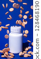 Falling Chewable Vitamin C Tablets with Bottle on Blue Background 128468190