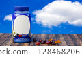 Vitamin Gummy Bottle on Wood with Cloudy Sky 128468206