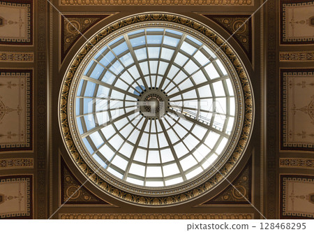 the large glass domed ceiling or skylight that forms part of the ceiling within the main hall or lobby of the National Gallery. the large glass domed ceiling or skylight that forms part of the ceiling within the main hall or lobby of the National Gallery. 128468295