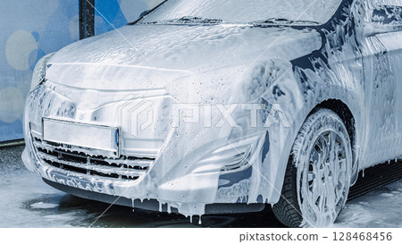 Car wash. Car cleaning foam soap bubbles. Spray water vehicle shine wet. Car wash. Car cleaning foam soap bubbles. Spray water vehicle shine wet. 128468456