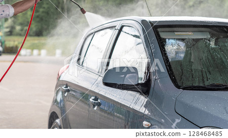 Car wash. Car cleaning foam soap bubbles. Spray water vehicle shine wet. Car wash. Car cleaning foam soap bubbles. Spray water vehicle shine wet. 128468485