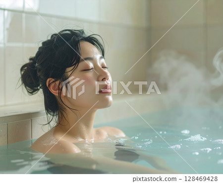 A woman relaxing in the bath 128469428
