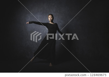 Woman posing against black background 128469673
