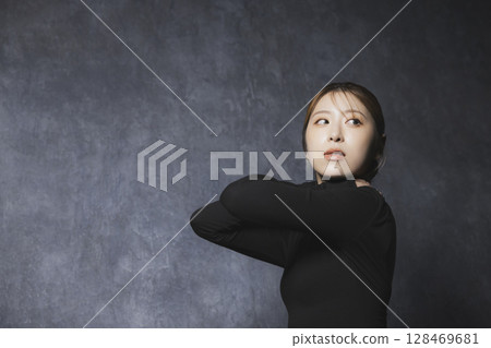 Woman posing against black background Woman posing against black background 128469681