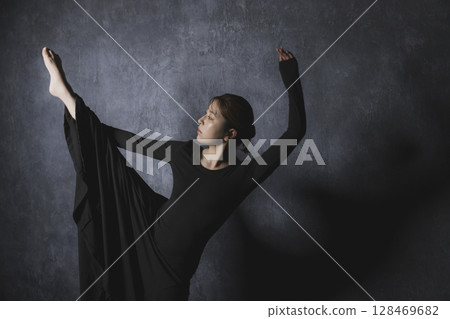 Woman posing against black background Woman posing against black background 128469682