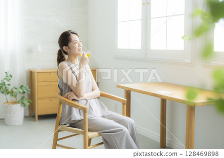Middle-aged woman drinking tea Middle-aged woman drinking tea 128469898