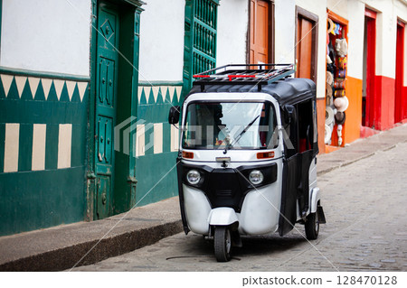 Traditional motor tricycle at the beautiful streets of the colonial town of Concepcion in Antioquia, Colombia. Traditional motor tricycle at the beautiful streets of the colonial town of Concepcion in Antioquia, Colombia. 128470128
