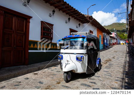 Traditional motor tricycle at the beautiful streets of the colonial town of Concepcion in Antioquia, Colombia. Traditional motor tricycle at the beautiful streets of the colonial town of Concepcion in Antioquia, Colombia. 128470134