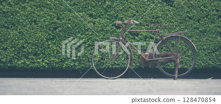 Vintage Bicycle on the wall decorate with bike cycle wheel in living room.Interior Design with people lifestyle hobby in a modern city. Bicycle with bulb lighting as background and loft decorate style 128470854