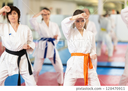 Women in a white kimono in training on a map Women in a white kimono in training on a map 128470911