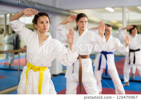Women in a white kimono in training on a map 128470967