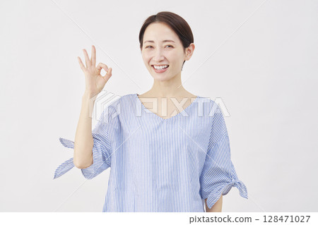 Woman middle-aged OK sign white background Woman middle-aged OK sign white background 128471027