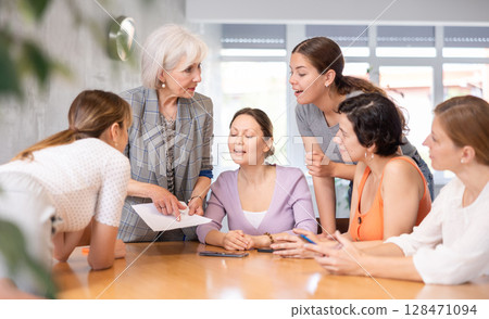 Senior woman participating in English language speaking club Senior woman participating in English language speaking club 128471094