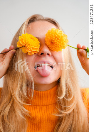 Woman in yellow sweater close her eyes with yellow dahlia Selective focus Bush of autumnal orange red chrysanthemums and violet dahlia hydrangea. Fall garden beautiful flowers bouquet background Woman in yellow sweater close her eyes with yellow dahlia Selective focus Bush of autumnal orange red chrysanthemums and violet dahlia hydrangea. Fall garden beautiful flowers bouquet background 128471281
