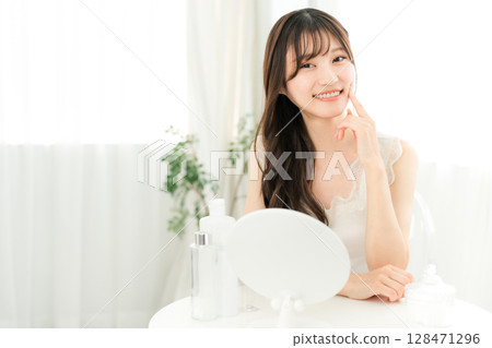 Skin care, young Asian woman doing face care (cheeks, moisture, elasticity, moisturizing) 128471296