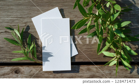 Blank flyer mockup placed on a wooden table with AI-generated images of green leaves 128471473