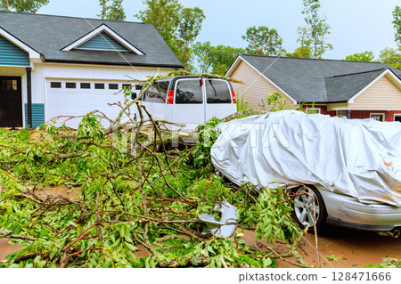 Storm damaged cars in quiet suburb showcase destruction from strong winds debris. Storm damaged cars in quiet suburb showcase destruction from strong winds debris. 128471666