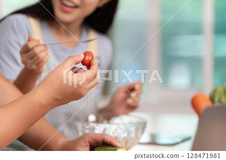 Healthy Cooking Together: Friends Preparing Fresh Ingredients in Modern Kitchen Healthy Cooking Together: Friends Preparing Fresh Ingredients in Modern Kitchen 128471981