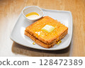 A classic Hong Kong style deep fried delicacy served at traditional cha chaan teng afternoon tea French toast drizzled with golden syrup 128472389