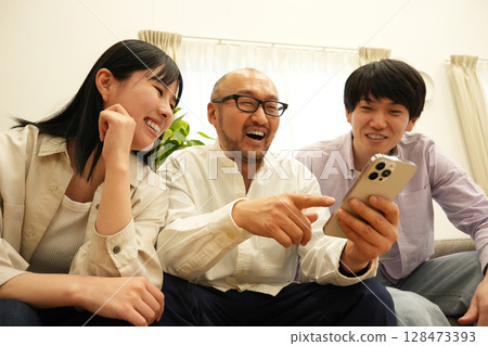 Families using smartphones Families using smartphones 128473393