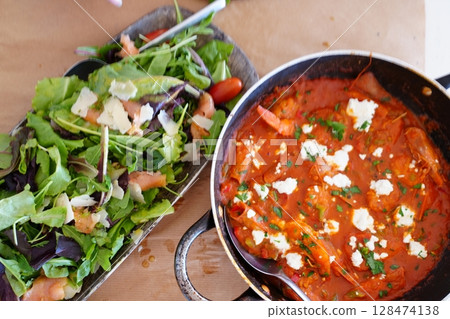 Fresh Salad and Savory Tomato Dish on Rustic Table 128474138