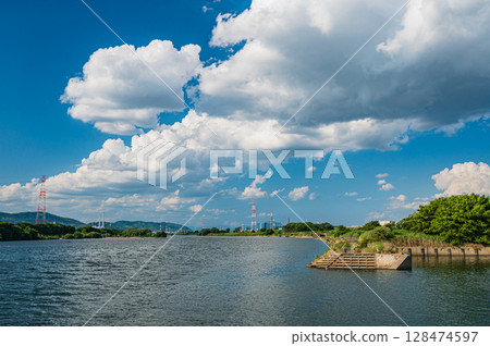 Summer scenery of the Yodo River, view from the Hirakata area of Yodo River Park, Hirakata City Summer scenery of the Yodo River, view from the Hirakata area of Yodo River Park, Hirakata City 128474597