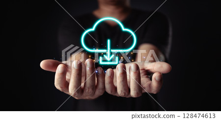 Data at your fingertips. Cloud computing is visualized with a glowing download icon above cupped hands, representing easy access and connectivity. 128474613