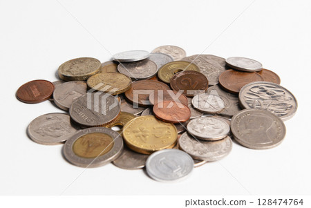 Pile of old coins isolated on white, blurry background. 128474764
