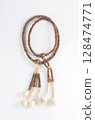 A wooden Juzu, a Japanese prayer beads, is a form of beadwork used to count the repetition of prayers, chants or mantras by members of various religions such as Buddhism and Shinto. 128474771