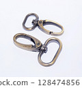 Brass lobster claw clasp or swivel hooks isolated on white. 128474856