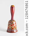 Decorative hand painted wooden hand bell. 128474861